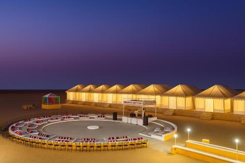 a large building with domes in the desert at night at Malra Heritage Resort Jaisalmer in Sām