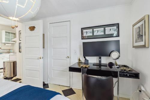 a bedroom with a bed and a desk with a computer at Ashtabula Cottage & RV-Minutes from Covered Bridges & Wineries in Ashtabula