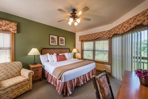 een slaapkamer met een bed, een bank en een stoel bij Westgate Branson Woods Resort in Branson