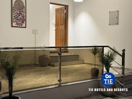 a lobby with potted plants in a building at Le Park Luxury Resort - TIE Hotels & Resorts in Puducherry