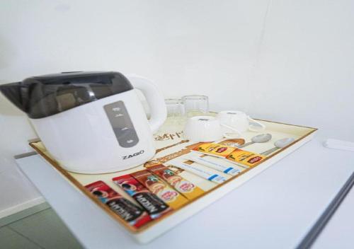 a counter top with a coffee maker and a toaster at RQ Timeless Dinsor Cultural Heritage House in Bangkok