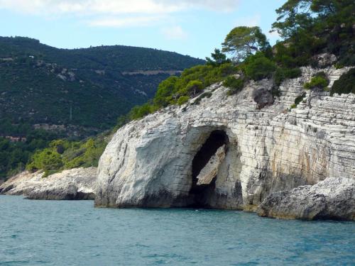 an arch in a rock formation in the water at Hotel Solaria in Rodi Garganico