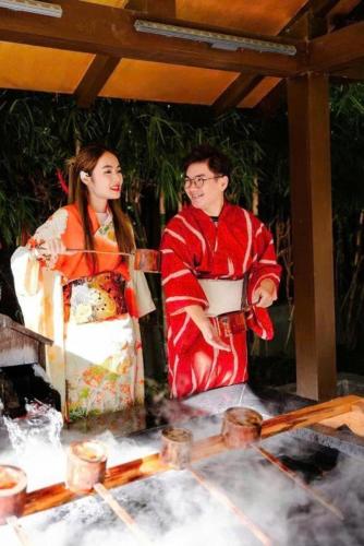 a man and woman in kimonos standing next to a table at Wyndham Lynn Times Thanh Thủy - Ks khoáng nóng 5 sao in La Phu