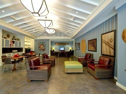 a living room with couches and chairs and a table at Aulani, Disney Vacation Club Villas in Kapolei