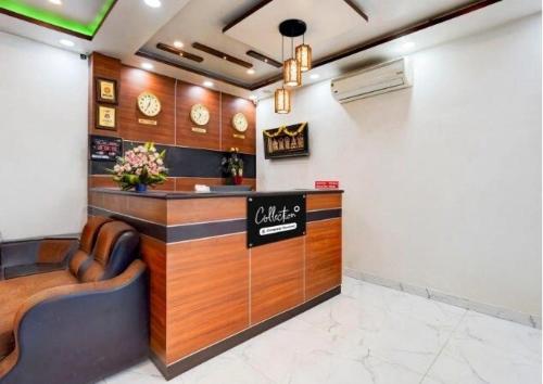 a restaurant with a counter and chairs in a room at Hotel O Kurnool City Railway Junction Formerly Diamond Court in Kurnool