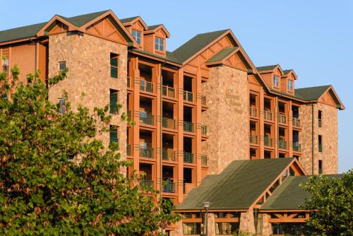 a large brick building with trees in front of it at Westgate Branson Woods Resort in Branson