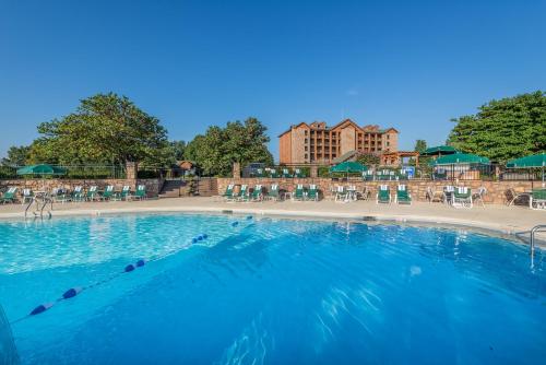 a large pool with chairs and tables in a resort at Westgate Branson Woods Resort in Branson