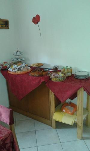 a table with a red table cloth with food on it at La Magnolia - Fano in Fano