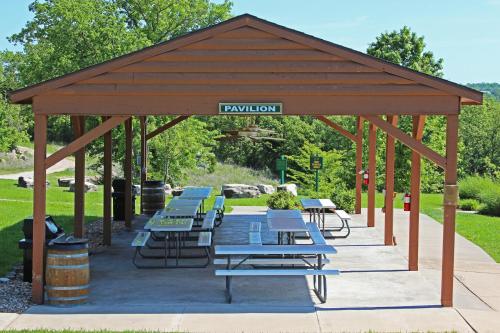 a pavilion with tables and benches in a park at Westgate Branson Woods Resort in Branson