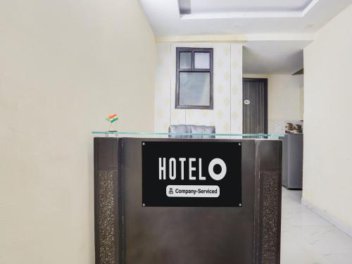 a hotel sign on a wall in a room at Super Hotel O Chhatarpur Formerly Royal Galaxy in New Delhi