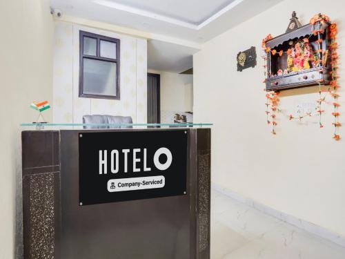 a sign for a hotel on a wall in a room at Super Hotel O Chhatarpur Formerly Royal Galaxy in New Delhi