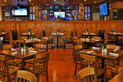 a restaurant with wooden tables and chairs and televisions at Westgate Branson Woods Resort in Branson