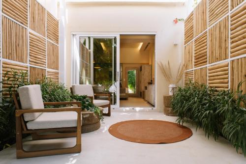 a living room with chairs and a rug at Sea Nymphs Suites in Agia Anna Naxos