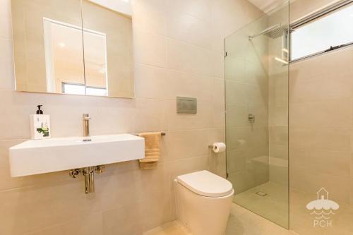 a bathroom with a toilet and a sink and a shower at 28 Ennisvale Avenue in Sandy Point