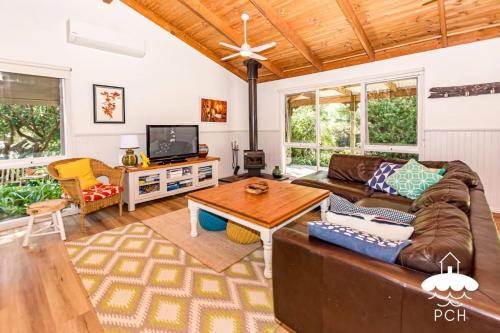 a living room with a couch and a table at Banksia Beauty in Sandy Point