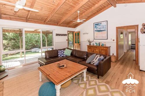 a living room with a couch and a table at Banksia Beauty in Sandy Point