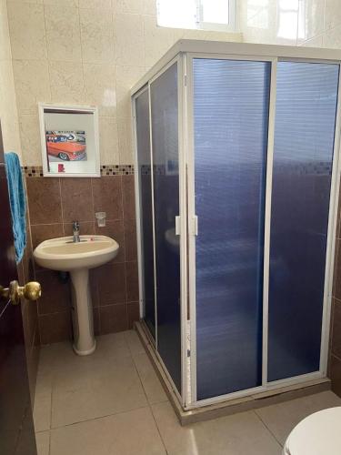 a bathroom with a shower and a sink at Lomas de Mazatlán in Mazatlán