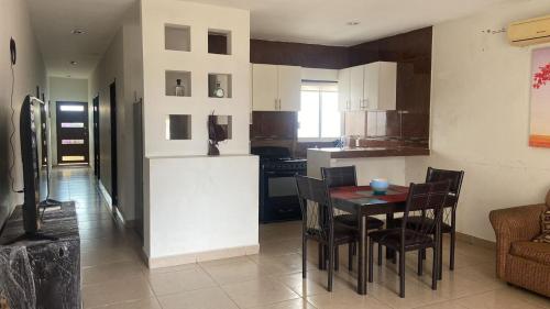 a kitchen and dining room with a table and chairs at Lomas de Mazatlán in Mazatlán