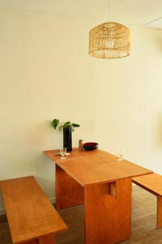 a wooden table with glasses and a potted plant on it at Pyoseon Mansion in Seogwipo