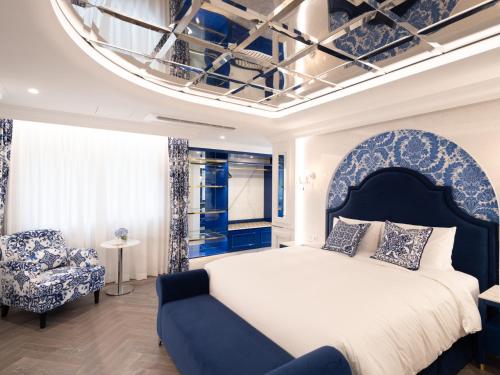 a bedroom with a large bed and a chair at The Siena PRIMO in Seogwipo