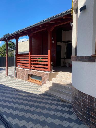 a building with a porch with stairs on it at Apartamentele Liliacul in Sighetu Marmaţiei