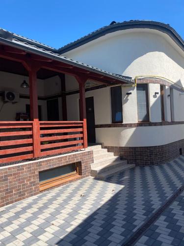a building with a porch and stairs on it at Apartamentele Liliacul in Sighetu Marmaţiei