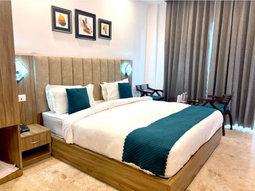 a bedroom with a large bed in a room at Hotel JP Hills Rishikesh in Rishīkesh