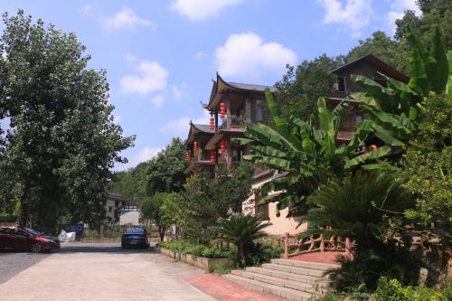 a large house with a balcony on a street at Wulingyuan Zhangjiajie National Forest Park Qique Villa in Zhangjiajie