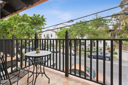 a balcony with a table and a view of a street at Casa Riviera - Boutique Suites in Downtown Santa Barbara in Santa Barbara