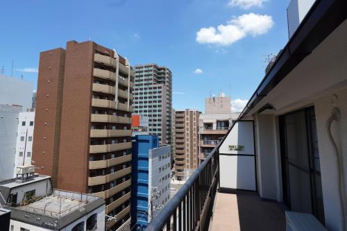 a balcony with a view of some buildings at Nihonbashi Royal in Osaka