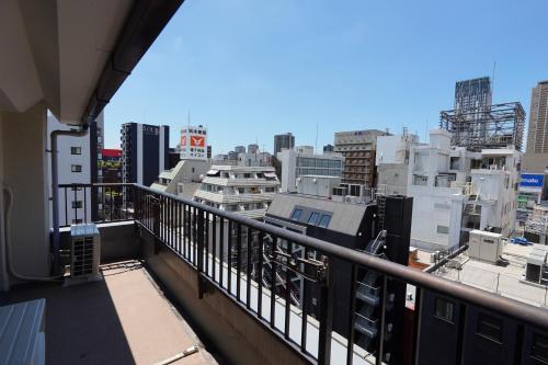 a balcony with a view of a city at Nihonbashi Royal in Osaka