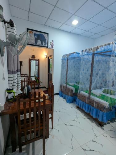 a room with two beds in a room at Nehansa Resort and safari in Tissamaharama