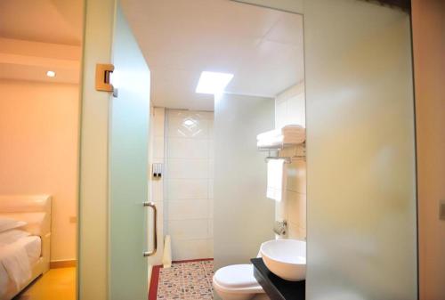 a bathroom with a toilet and a shower at Jian Guo Grand Hotel in Vientiane