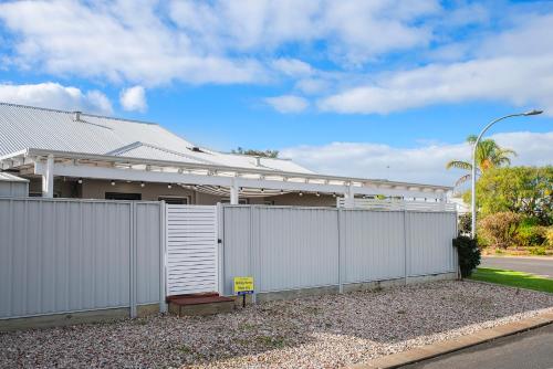 a white fence in front of a house at Lazy Daze Beach House in Quindalup