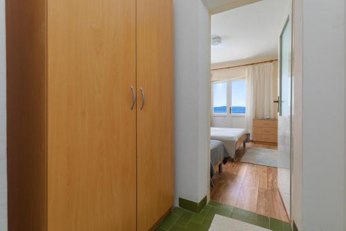 a room with a closet and a bedroom with a bed at Apartments and rooms by the sea Podgora, Makarska - 2616 in Podgora