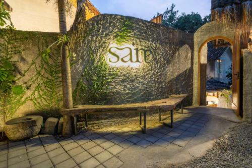 a bench sitting outside of a building with the sale sign at Villa Sare - House with panorama rice field view in Yogyakarta