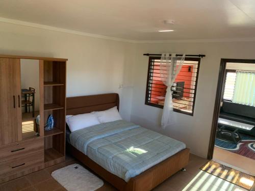 a bedroom with a bed and a window at Kananafouairbnb in Nadi