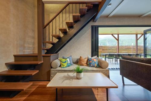 a living room with a couch and a table at Resoreat Shirahige in Takashima