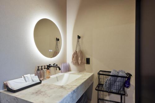 a bathroom with a sink and a mirror at Resoreat Shirahige in Takashima