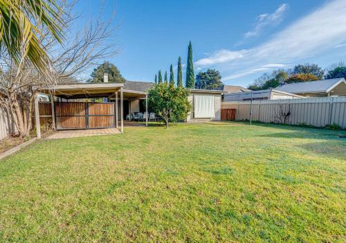 a house with a fence and a yard at Just the Spot in Myrtleford