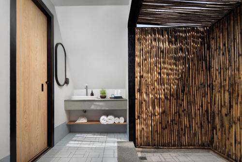 a bathroom with a shower with a sink at Summer Bay Beach Club & Cabins Sihanoukville by Preference in Sihanoukville
