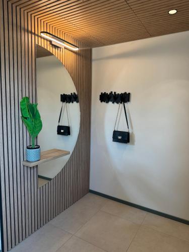 a hallway with a mirror and a plant on a wall at Kreutzwaldi Kodu 3 in Võru