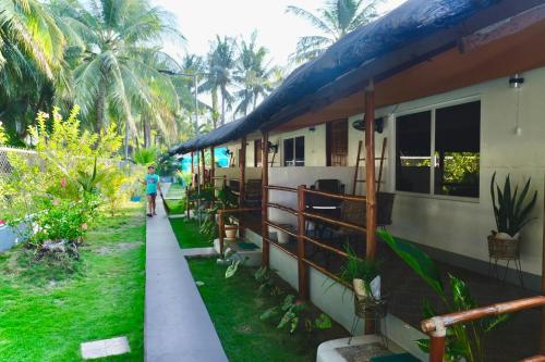 a person standing outside of a house at Skott's Comfy Lodge in Bantayan Island