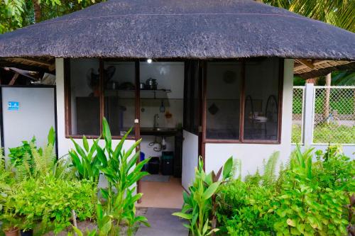 a small house with a thatched roof at Skott's Comfy Lodge in Bantayan Island