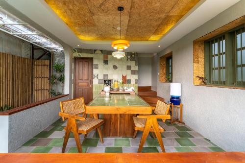 a dining room with a table and chairs at Villa Sare - House with panorama rice field view in Yogyakarta