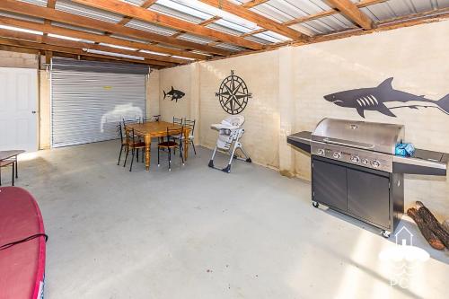 a kitchen with a table and a stove and a dining room at Fishermans Stay 