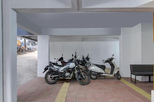 a group of motorcycles parked in a room at Hotel O Sai Executive Lodging in Māngvādi