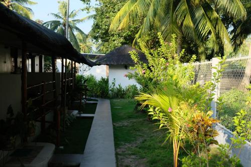 a path through the garden of a house at Skott's Comfy Lodge in Bantayan Island