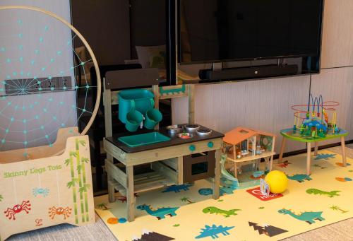 a play room with a pretend kitchen and a table at DoubleTree By Hilton Cangnan in Cangnan