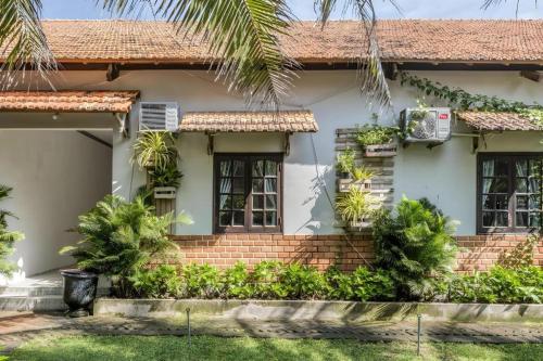 a house with plants in front of it at HON BA LAGI BEACH RESORT in La Gi